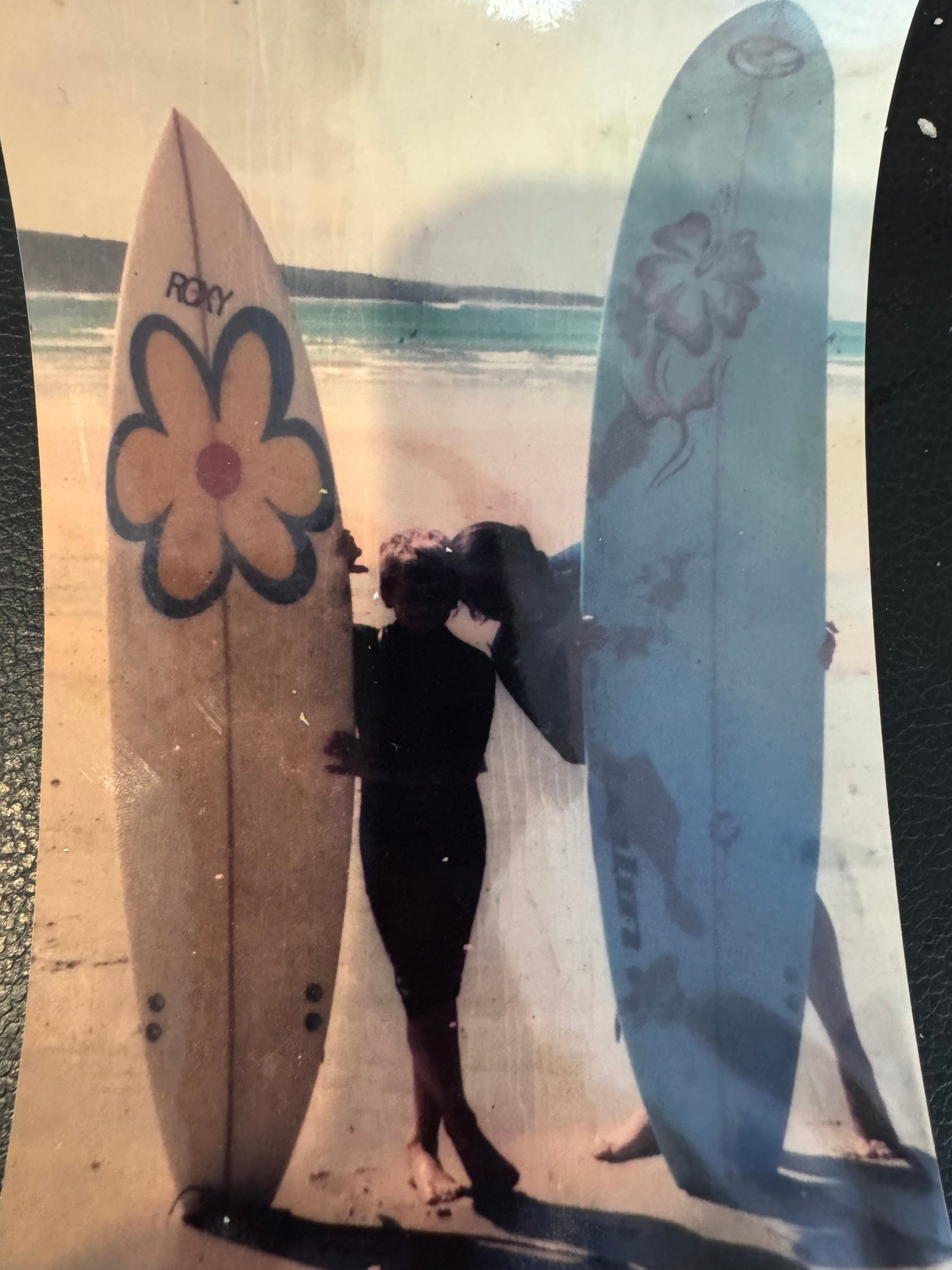 Sarah and Dan with their surfboards on the beach